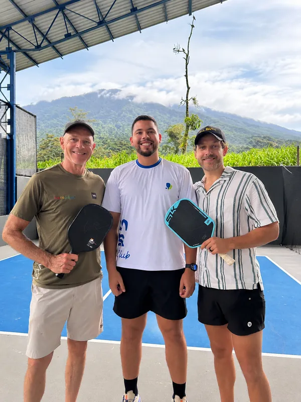 Three players with their paddles at Volcan Courts Pickleball Club, La Fortuna